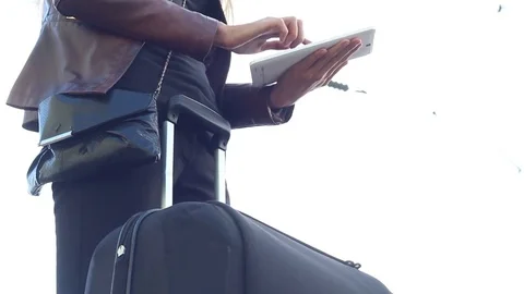 Girl with a suitcase at the station using a tablet Stock Footage 77076941