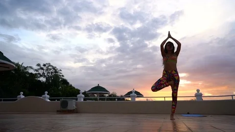Girl at sunset practicing yoga Stock Footage 75230102