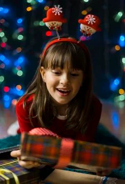 Girl Suprized by Christmas Gift Box Stock Photos