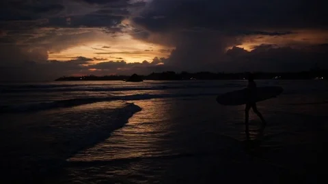 Girl with surfboard at sunset Stock Footage 87762444