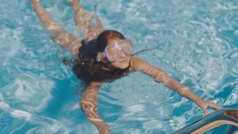 The girl is swimming in the pool Stock Footage 80739401