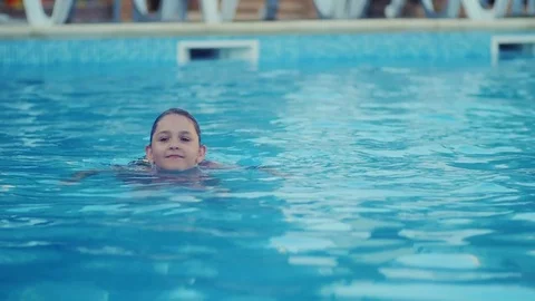 The girl is swimming in the pool Stock Footage 80739631