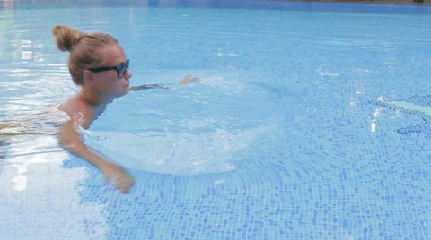 Girl swims in the pool Stock Footage 67467577