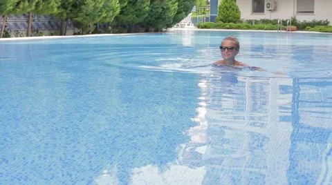 Girl swims in the pool Stock Footage 67759618