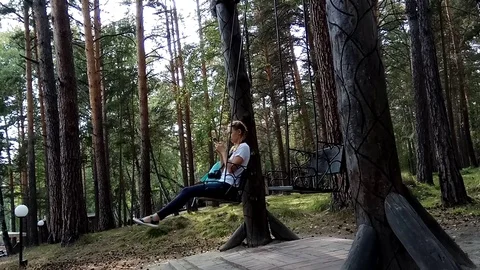 Girl on a swing in the forest Stock Footage 115546471