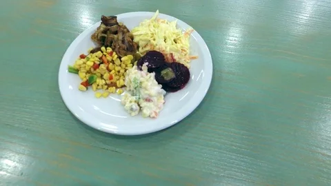 A girl at the table eats salads. Stock Footage 77409108