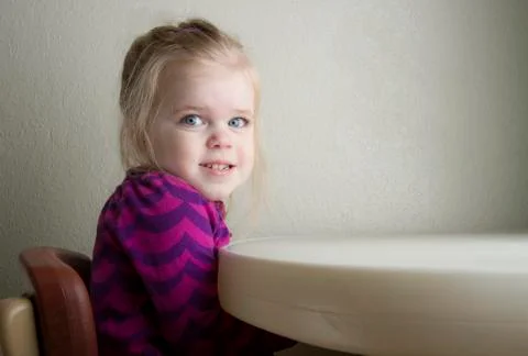 Girl at the table Stock Photos