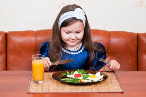 Girl at the table Stock Photos