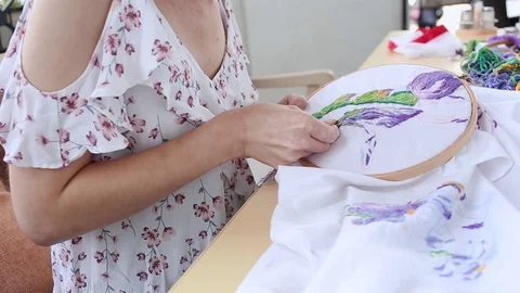 Girl at table sewing with needle. needlework, embroidery, hobby, handicraft Stock Footage 118691196