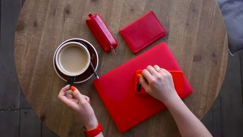 Girl table sits drinking coffee on the street and prepares for a further journey Stock Footage 137564234
