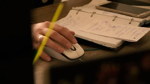 The girl at the table works on a computer mouse.It works fast. Stock Footage 125419768