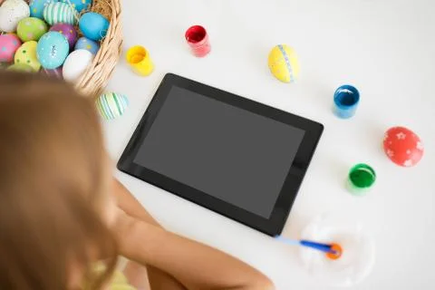 Girl with tablet computer, easter eggs and colors Foto stock