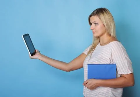 Girl with tablet computer ebook reader and book Stock Photos