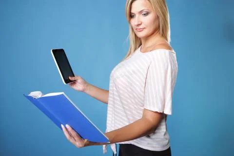 Girl with tablet computer ebook reader and book Stock Photos
