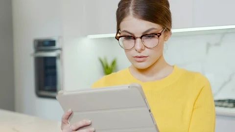 Girl with a tablet in the kitchen Stock Footage 116767977