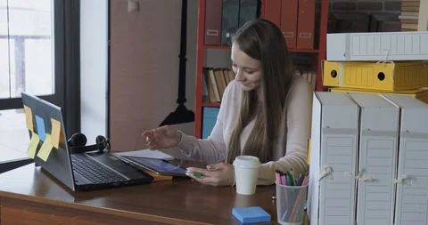 Girl on tablet opened calculator application, considers total amount on checks Stock Footage 129841480
