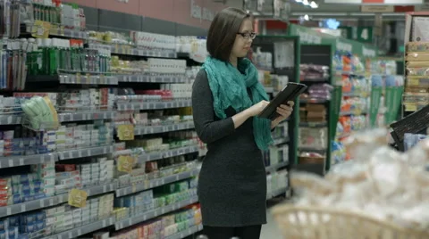 Girl with tablet PC in store Stock Footage 67981566