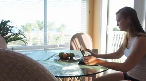 Girl with a tablet at table Stock Footage 48752571