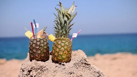 Girl takes a cocktail Pina colada in pineapple with a flag of Cyprus and pipes Stock Footage