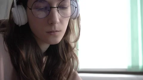 A girl takes notes in a notebook from her laptop. Stock Footage 171909249