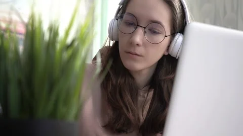 A girl takes notes in a notebook from her laptop. Stock Footage 171909653