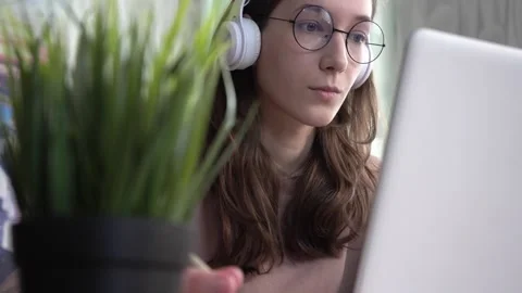 A girl takes notes in a notebook from her laptop. Stock Footage 172259171