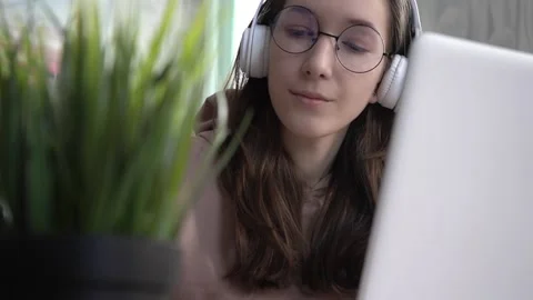A girl takes notes in a notebook from her laptop. Stock Footage 181970137