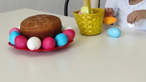 Girl takes out Easter eggs from a basket Stock Footage 152531157