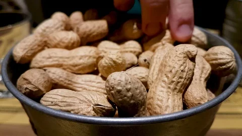 A girl takes peanuts from a container in a fast food restaurant Video stock 101046532