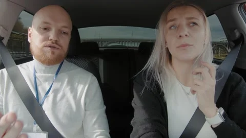 The girl is taking a driving test with an instructor. An inexperienced student Video stock 165781211