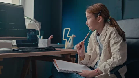 Girl Taking Notes while Learning to Code on Computer at Home Stock Footage 319736934