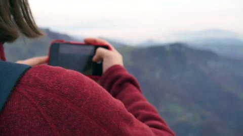 Girl taking a photo in the mountain Stock Footage