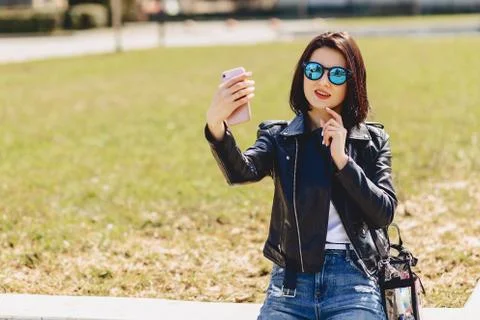 Girl taking selfie on phone and smiling Stock Photos