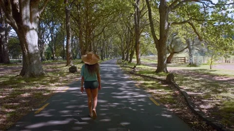 Girl taking a stroll through Cornwall park, auckland, New Zealand Stock Footage 171749629