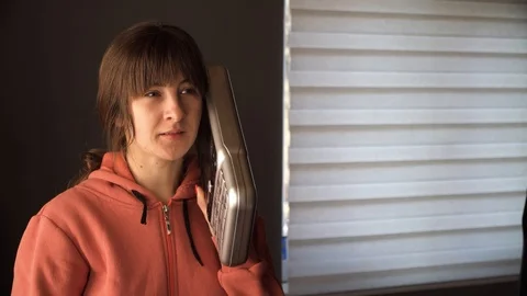 The girl is talking on the big phone Stock Footage 123583653