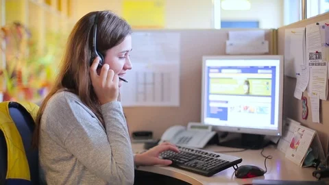 Girl talking with a client in a call center Stock Footage 71656107