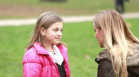 Girl talking with her mom in park Stock Footage 59554638