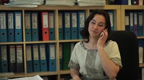 Girl talking on the phone in the office. Stock Footage