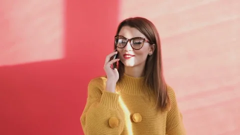 Girl talking on the phone outside the house Stock Footage