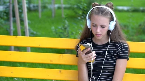 Girl talking while looking at smart phone Stock Footage 94464926