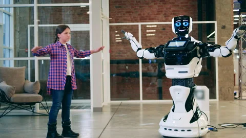 A girl is teaching a cyborg to do exercises Video stock 149761092