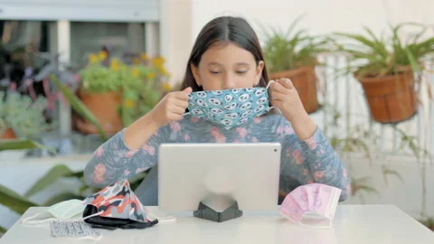 Girl teaching various types of face masks on video conference 스톡 동영상 148060397
