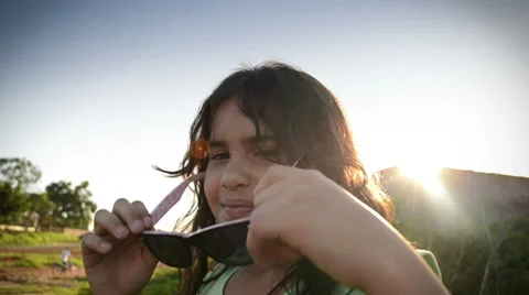 Girl testing sunglasses 库存影片 35610846