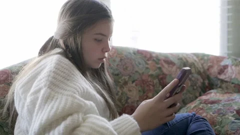 Girl texting on couch Video stock 168490179