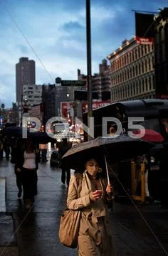 Girl Texting in the Rain, in NYC Stock Photos