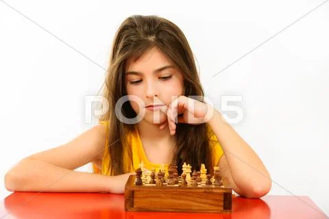 Girl thinking a chess game isolated on white background Stock Photos