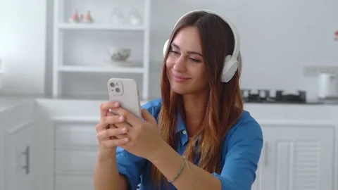 Girl is thinking what to write in an answer to friend on smartphone app Video stock 179504963