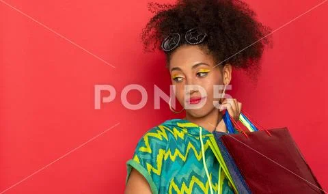 Girl thoughtfully sad with packages in hand Stock Photos