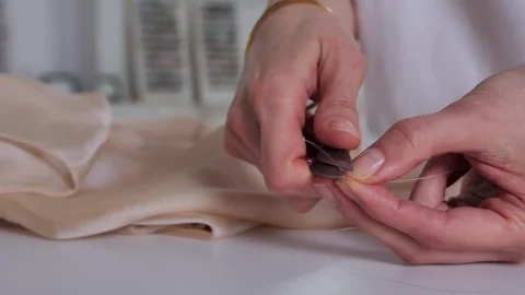 The girl threads a needle Stock Footage 274413606