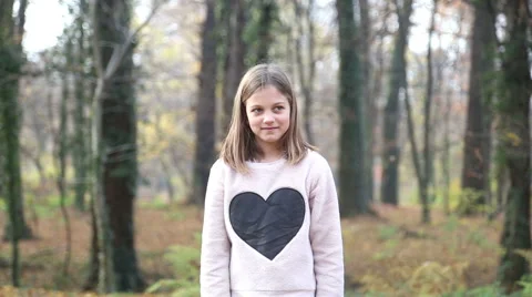 Girl throwing leaves and spinning around in the park Stock Footage 59553822